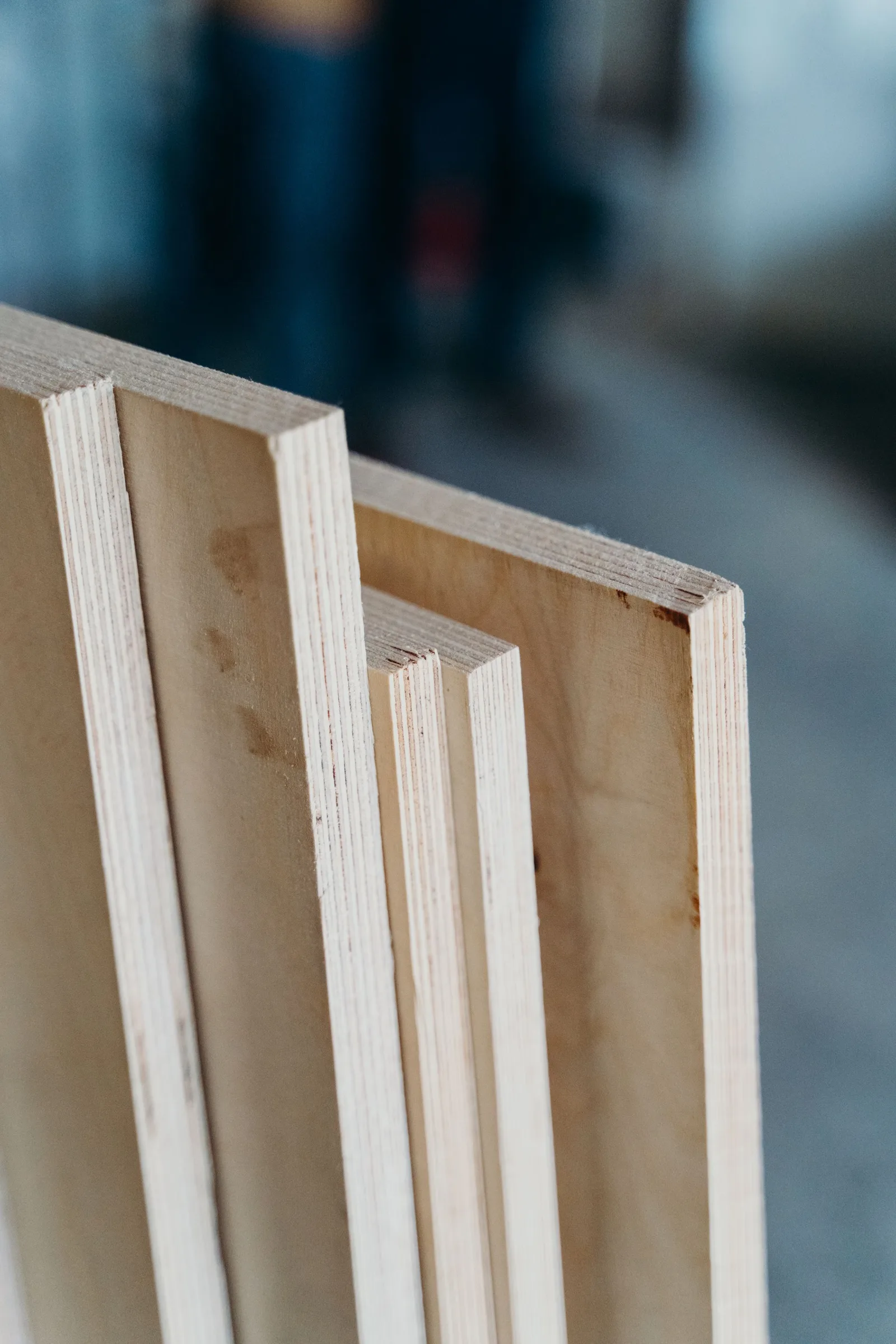 The pale, layered edges of plywood panels in a workshop.